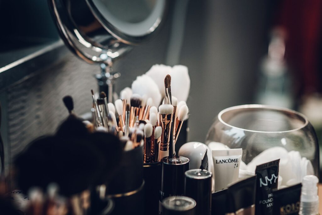 A selection of minimalist makeup products including tinted moisturizer, concealer, mascara, and lip balm for a natural, effortless look